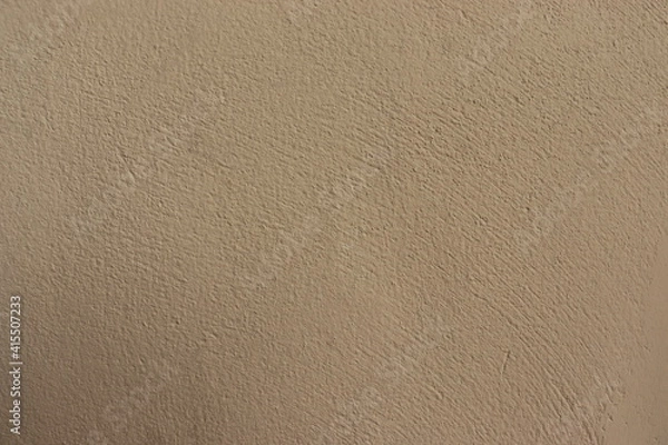 Fototapeta The walls are made of cream stucco, with a rough and rough surface. There is a blank space for the text. Ideas for background.