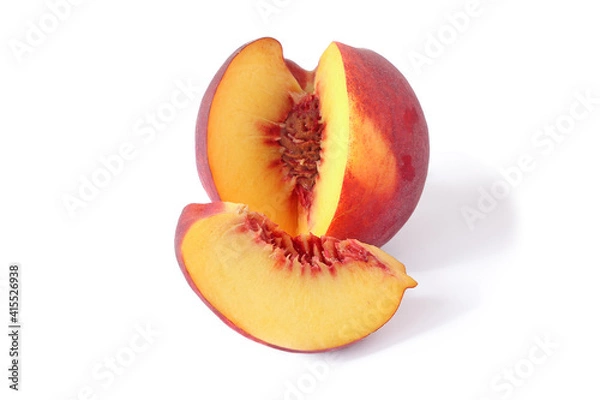 Fototapeta Cut peach and slices isolated on white background