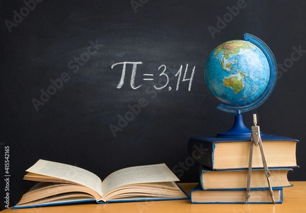Fototapeta The Greek letter Pi, the ratio of the circumference to its diameter, is drawn in chalk on a black school board with books, a globe and a compass in honor of the international number Pi for March 14
