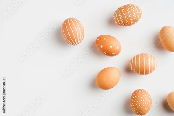 Fototapeta Happy Easter card. Simple painted Easter eggs isolated on white background. Flat lay, top view