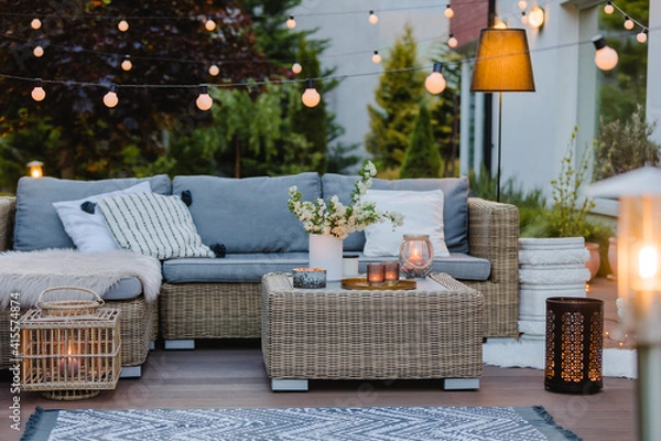 Fototapeta Summer evening on the patio of beautiful suburban house with garden