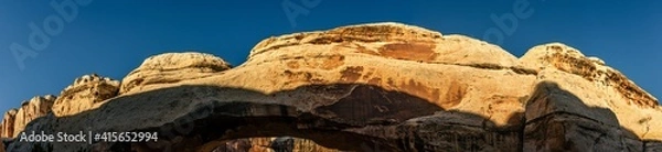 Fototapeta Close up of sandstone arch against blue sky in Capitol Reef national park in Utah, america