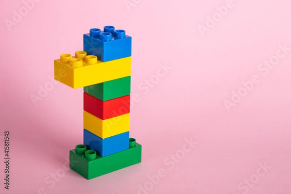 Fototapeta Color plastic building blocks on pink background