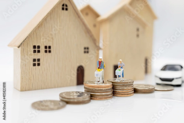 Fototapeta Miniature people: Parent and children with shopping cart standing on coins stack with house and car.  Concept of shopping in housing and vehicles.
