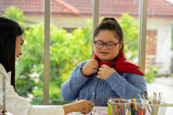 Obraz Asian Autism girl playing and learning in special school with young teacher