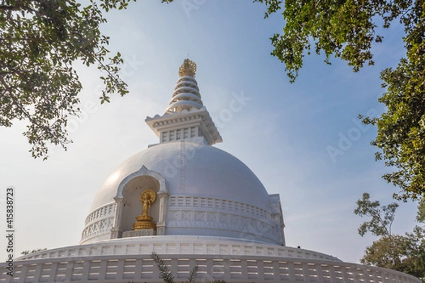Fototapeta buddhist stupa isolated with amazing blue sky from unique perspective