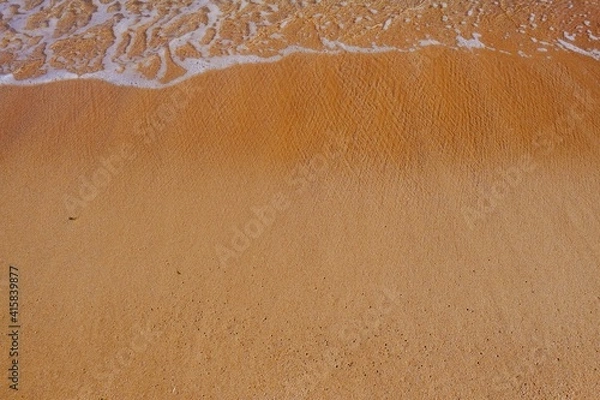 Fototapeta Sand beach with white sea soft foam wave on top view in thailand for assembling an article about travel in summer holiday or ocean sand beach coast nature.