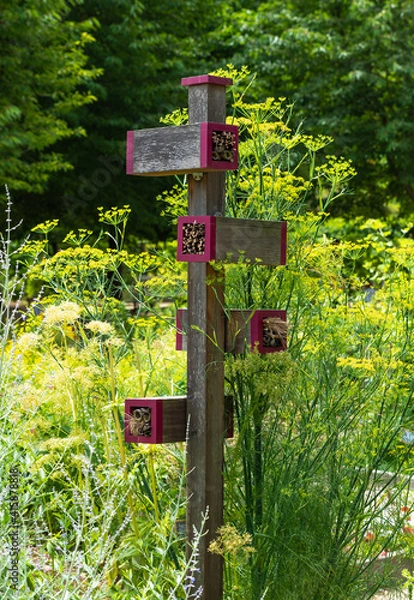 Obraz Insect hotel in a summer garden during day.