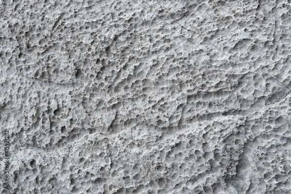 Fototapeta Full-screen texture of weathered and eroded gray limestone