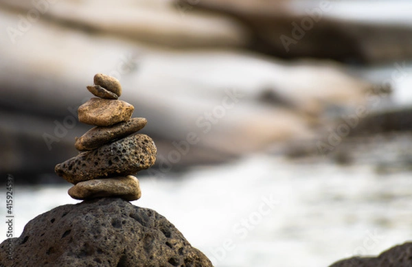 Fototapeta Closeup of a stone stack. Stone stacking is often associated with spirituality, especially in the areas of balance and patience. 