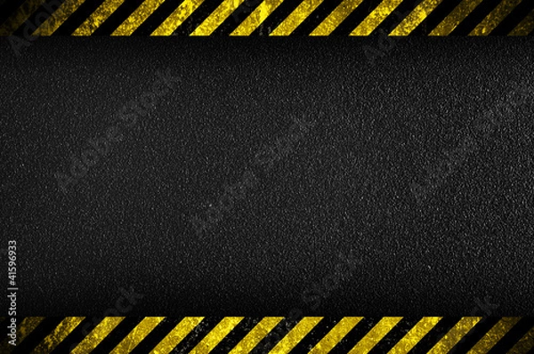 Fototapeta Dark background with yellow caution stripes