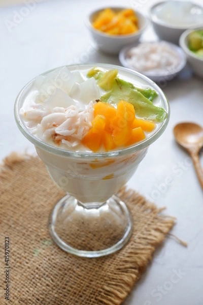 Fototapeta a glass of es teler or various fruits with coconut milk soup and ice cubes
