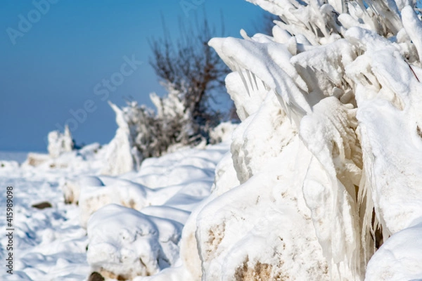 Fototapeta Shapeless ice figures that formed due to the storm