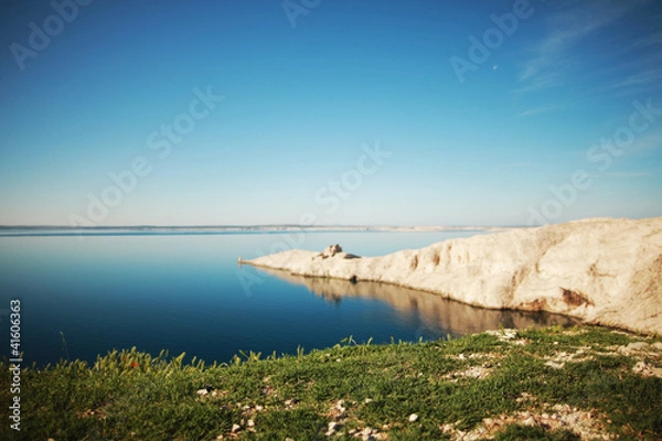 Fototapeta Lighthouse at Adriatic sea by island landscape