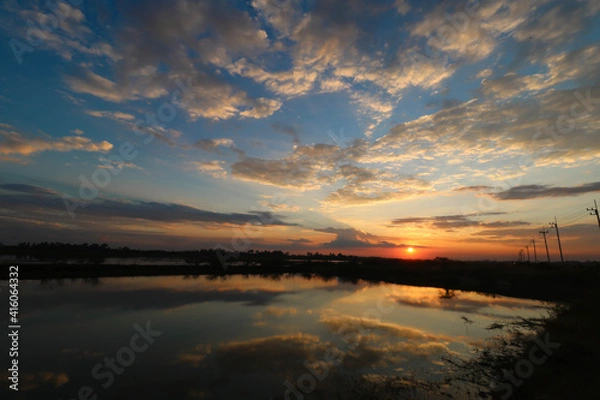 Fototapeta A sunset and reflection of the sky on the water of the lake