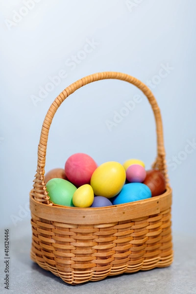 Fototapeta a basket full of colorful colored eggs for the Easter holiday