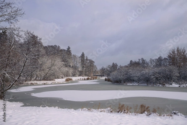 Fototapeta Landscape in a winter scenery with a frozen lake.