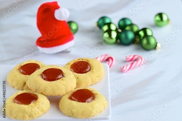 Fototapeta Thumbprint cookies on white background with Christmas decoration
