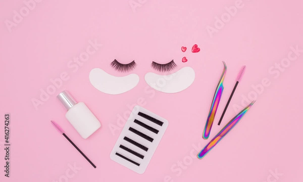Obraz Tools and patches for eyelash extensions and artificial eyelashes on a pink background. Tools for the lashmaker. The view from the top.