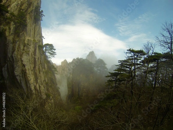 Fototapeta China Mount HuangShan - April, 2015: Natural scenery, sunsets, peculiarly-shaped granite peaks, Huangshan pine trees and views of the clouds from above. Photo taken in Yellow Mountain (UNESCO).