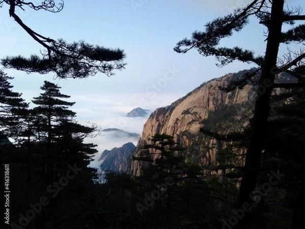Fototapeta China Mount HuangShan - April, 2015: Natural scenery, sunsets, peculiarly-shaped granite peaks, Huangshan pine trees and views of the clouds from above. Photo taken in Yellow Mountain (UNESCO).