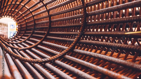 Fototapeta reinforcement concrete and plastic orange net. Inside view of rebar for reinforced hole in the ground. Texture background net metal red