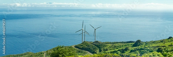 Fototapeta Three wind turbines on the coast of the Canary Island of La Palma, Spain, in the background the Atlantic Ocean