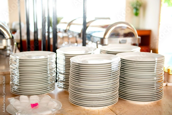 Fototapeta The plates of food were stacked on top of the table, plastic gloves before picking up the plates