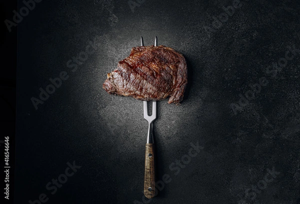 Fototapeta grilled beef steak on a dark background. expensive marbled beef of the highest grade fried to rare on the grill