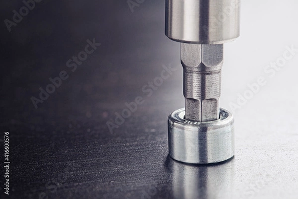 Fototapeta Hex drill bit screw hex bolt in metal steel plate. Spanner, bolt, screw and nuts.