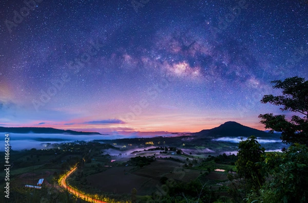 Fototapeta Milky Way galaxies on mountain vantage points in nature, distant photographs with grainy or noisy images, and soft focus.