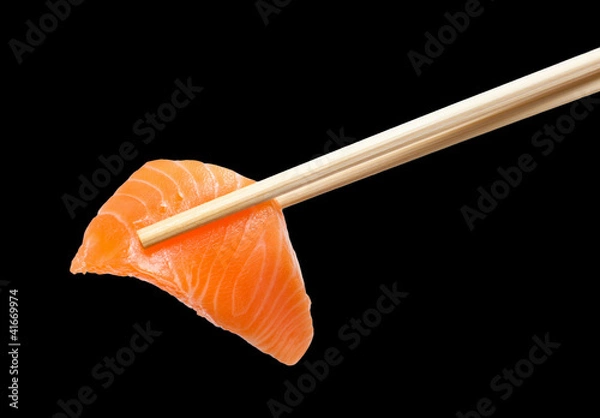 Fototapeta Chopsticks with sliced raw salmon
