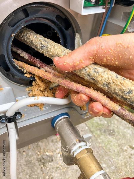 Fototapeta Heating element of water heater with a lot of chalk and damaged