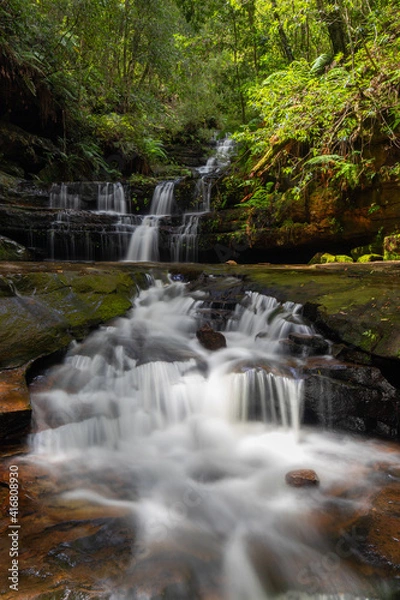 Obraz Water flowing through multi-level waterfalls.