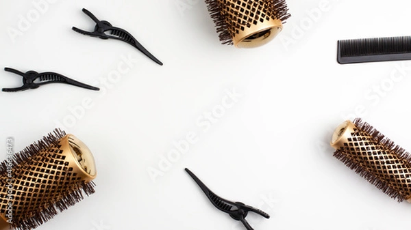 Fototapeta Top view flat lay of tree professional gold round hair brushes for styling,comb for separating hair and section hair clips template with copy space. Hairdresser salon equipment concept, premium set.
