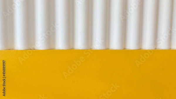 Fototapeta blur image - A white cement wall with a corrugated texture and yellow cement wall for background