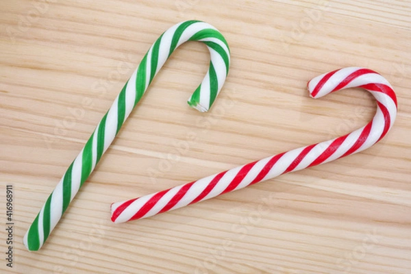 Obraz Candy canes on wooden background