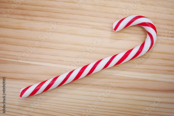 Obraz Candy cane on wooden background