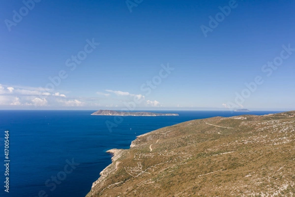 Fototapeta Aerial drone shot of Adriatic sea horizon with Bisevo Island in Croatia summer morning