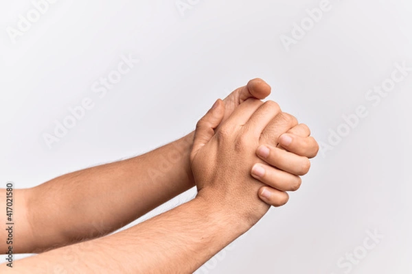 Fototapeta Hand of caucasian young man showing fingers over isolated white background holding both hands together, clapping and cheering for celebration