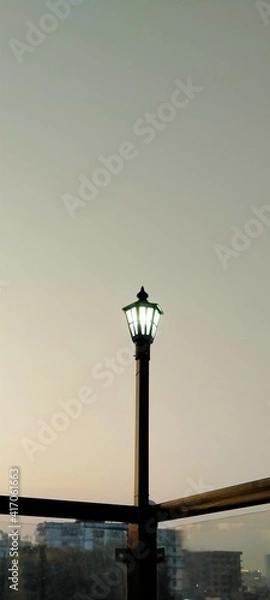 Obraz A lamp with a light blue background