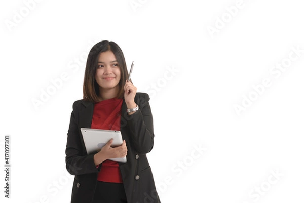 Obraz Asian business woman is holding a tablet and the other hand holding a pen and expressing joy. On white Background.