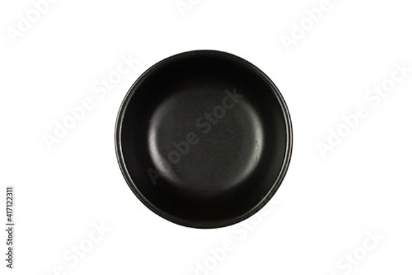 Fototapeta Small black bowl isolated on white background, Top view. The bowl is a kitchen utensil for holding food.