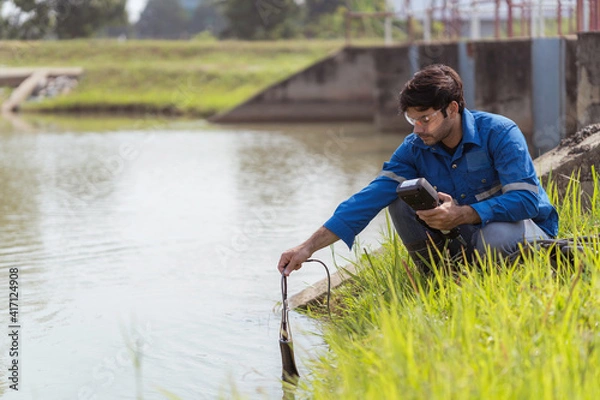Obraz A technician using portable multi parameter water quality measurement