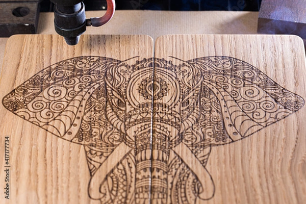 Obraz laser engraves the image of an Indian elephant on a wooden surface