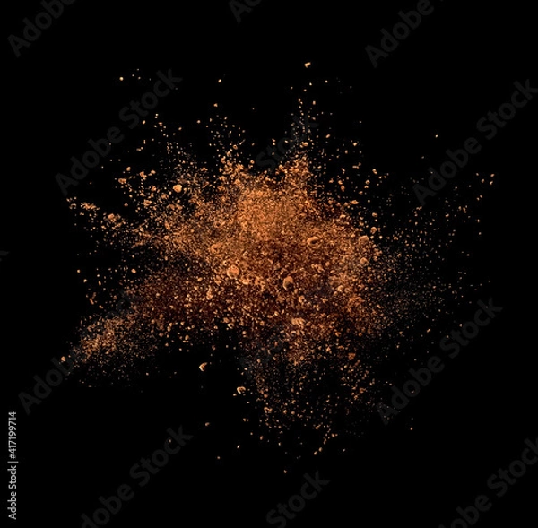 Obraz Cocoa powder explosion on black background
