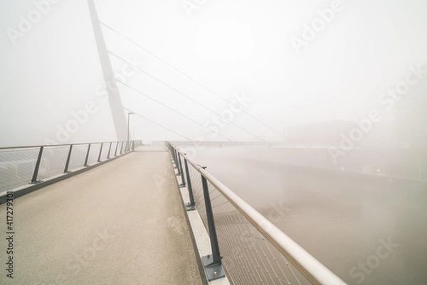 Fototapeta bicycle pedestrian bridge with fog
