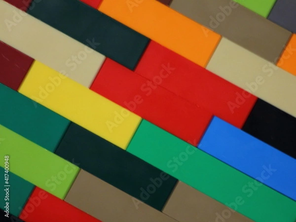 Fototapeta Colorful plastic bricks diagonal lines wall surface, children's construction kit  mosaic block background texture