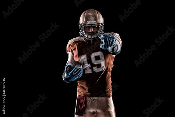 Fototapeta Football Player with a orange uniform coming out of a stadium tunnel.