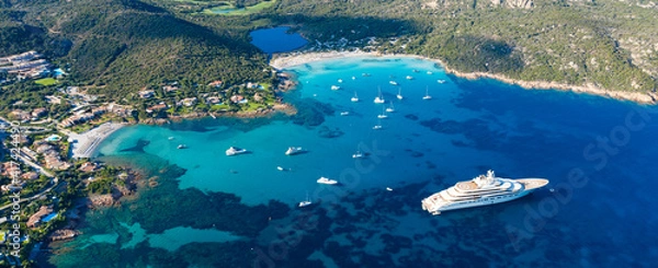 Obraz View from above, stunning aerial view of the Grande Pevero beach with boats and luxury yachts sailing on a turquoise, clear water. Sardinia, Italy.
